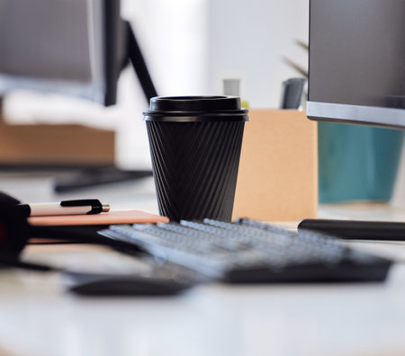 Youll always find a cup of coffee on my desk. Closeup shot of a coffee cup on a desk in an office.