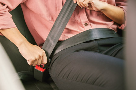 Buckle up, its for your own good. a unrecognizable woman fastening her seatbelt in a car.の写真素材