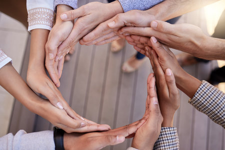 Everything is a process. a group of unrecognizable businesspeople forming a circle with their hands...