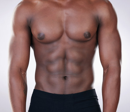 Being fit is a choice. an unrecognisable man standing alone in the studio and posing shirtless.の写真素材