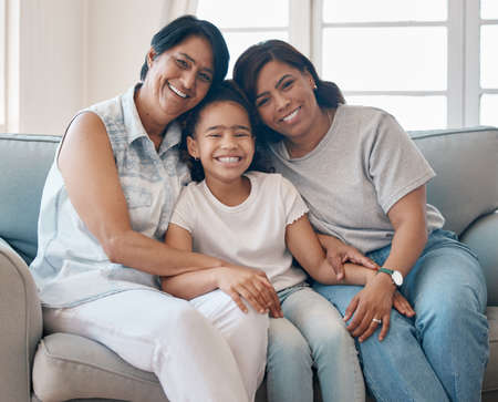 Time with family warms my heart. a young woman spending time with her mother and daughter.の写真素材