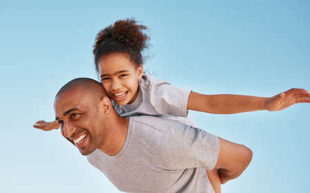 Be free to be you. a little girl and her father spending time at the beach.の写真素材