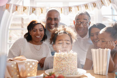Your age isnt you. Use today to feel your best. a happy family celebrating a birthday at home.の写真素材