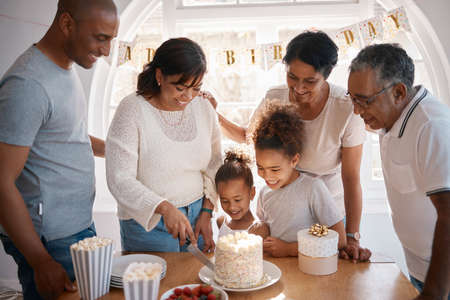 The secret of staying young is to live honestly. a family cutting a cake and celebrating a birthday...