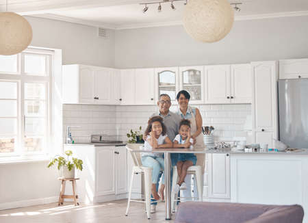 The kitchen is the heart of the home. grandparents spending time baking with their granddaughters.