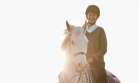Traveling through nature with my favourite four-legged friend. a beautiful young woman out horseback riding.の写真素材