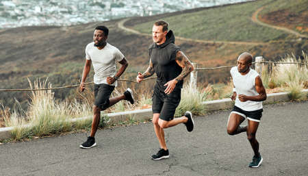 Dont give up now. a group of men exercising in nature.の写真素材