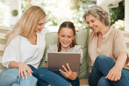 Technology brings family together. a grandmother spending time with her daughter and granddaughter while using a digital tablet.の写真素材
