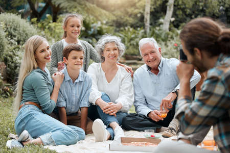 On the count of three. a multi-generational family spending time together outdoors.の写真素材