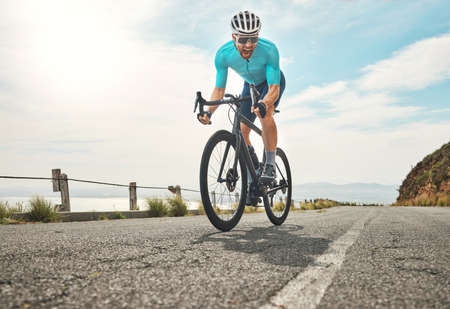 He crushed that ride. Full length shot of a handsome mature man shouting while cycling outdoors.の写真素材