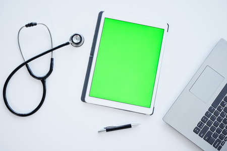Ready to help any patient. an empty medical office with a table filled with tech equipment.