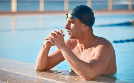 a handsome young male athlete swimmingの写真素材
