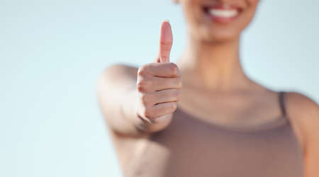 Just go for it. Closeup shot of an unrecognisable woman showing thumbs up while exercising outdoors.