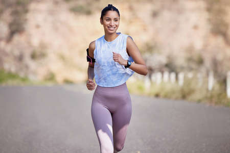 Shes on form. an attractive young female athlete enjoying a run outdoors.の写真素材