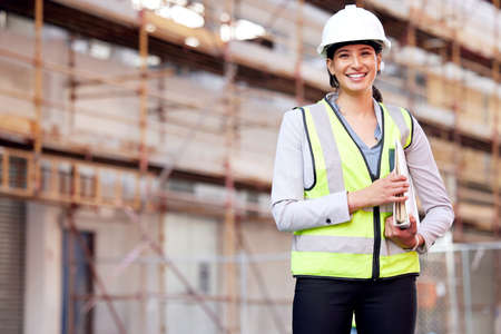 Putting in the final touches. a young woman working on a construction site.