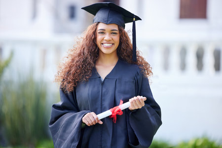 Nothing can stop me now. Portrait of a young woman holding her diploma on graduation day.の写真素材