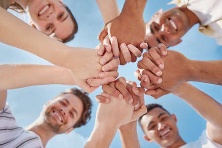 Friends will always be there to hold your hand. a group of young people holding hands outside.