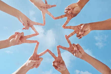 Youre the brightest star there is. a group of unrecognizable people making a star shape with their fingers.の写真素材