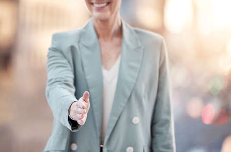 Shall we shake on it. an unrecognisable businesswoman standing in the city with her hand outstretched.の写真素材