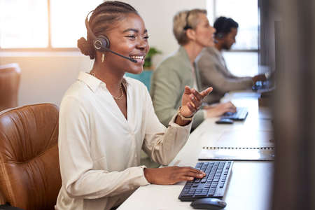 Your problem is our solution. a beautiful young woman working in a call center.の写真素材