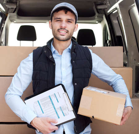 Were rated top in the industry. Portrait of a young delivery man loading boxes from a van.