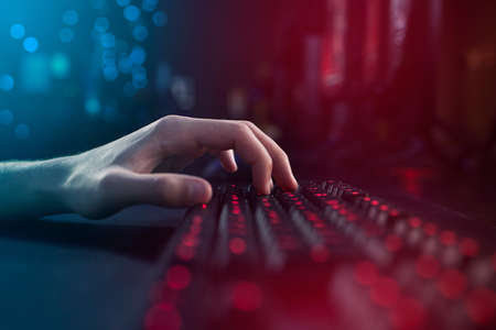 He who controls the keyboard controls the game. an unrecognisable man using a keyboard while playing...
