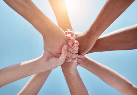 Everyone needs a hand to hold. a group of unrecognizable people holding hands.