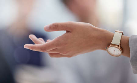 Im open to new ideas. an unrecognisable businesswoman explaining to a group of colleagues in the office.の写真素材