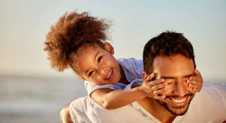Home is people. Not a place. a father carrying his daughter at the beach.