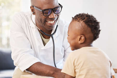 The heart of a champion. a doctor examining an adorable little boy with a stethoscope.の写真素材
