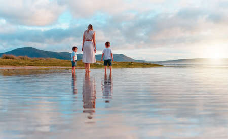 Cherish these moments. a young family spending a day at the beach.の写真素材