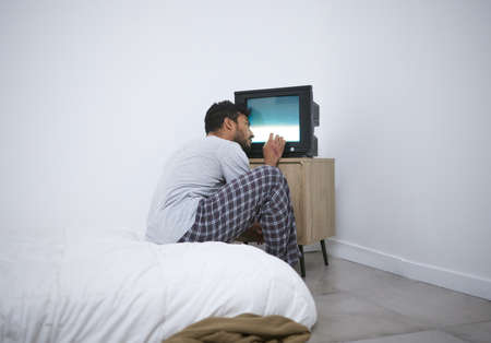 he fear is real but the danger is not. a mentally ill man watching tv in an asylum.