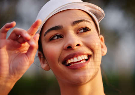 Heres to having more good days. Closeup shot of a tennis player wearing a white visor.の写真素材