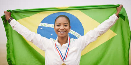 When I win, my country wins. Cropped portrait of an attractive young female athlete celebrating a victory for her country.の写真素材