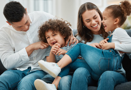 Always remember to play. a young family playfully tickling one another.の写真素材