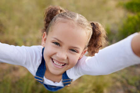 Come out to play. an adorable little girl having fun outdoors.の写真素材