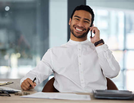 What a successful business day. a young businessman making a phone call using his smartphone.