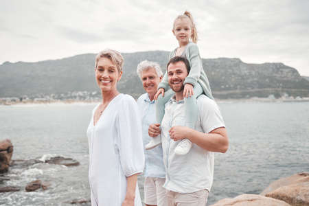 My happy place is wherever they are. a happy family enjoying a day along the coast.の写真素材