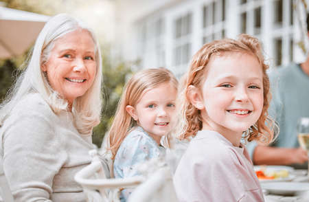 Go home and love your family. two girls and their grandma sitting at a tablet at home.の写真素材