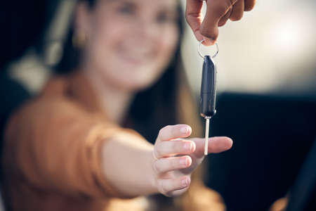 Celebrate the small victories. a unrecognizable woman getting her new car key outside.の写真素材