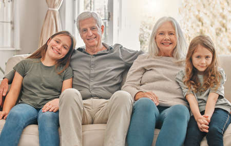 We love spending time with them. two sisters spending time with their grandparents at home.
