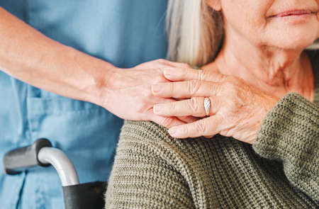 Connected through the hands of time. a mature woman being supported by her nurse.の写真素材