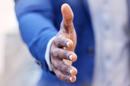 Lets do business. an unrecognizable businessman extending his hand for a handshake at work.の写真素材