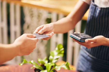 No need to carry a wallet. a customer using a card and an NFC scanner to make a card payment.