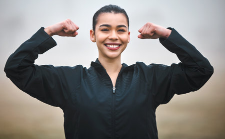 Subtle flex. Cropped portrait of an attractive young female athlete flexing her biceps while...