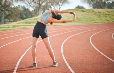 Stretching is a powerful signal to strengthen muscles. Rearview shot of a young athlete stretching...