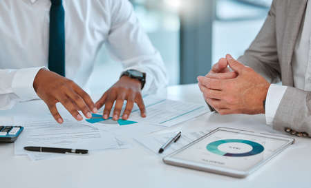 The quickest way to double your money is to invest. two unrecognizable businessmen working on...