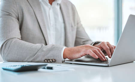 Money is better than poverty, if only for financial reasons. a unrecognizable man using a laptop in...