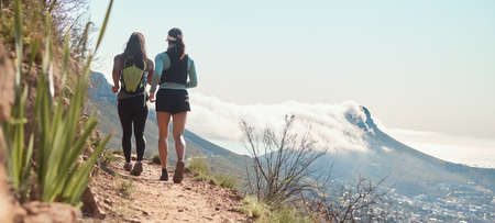 We will finish this trail together. Rearview shot of two young women running along a trail on the...