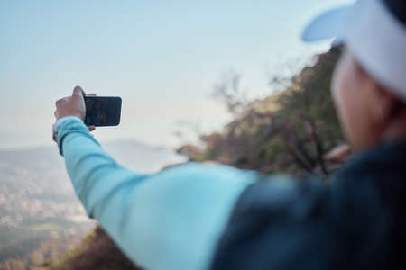 Hiking allows us to unplug from busy life for a bit. two young women taking selfies during a hike...